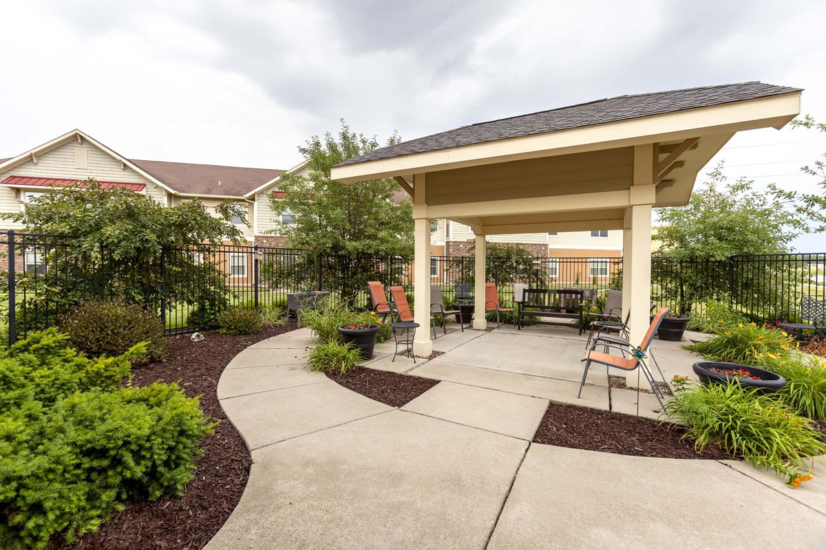 A peaceful garden patio with a gazebo and outdoor seating.