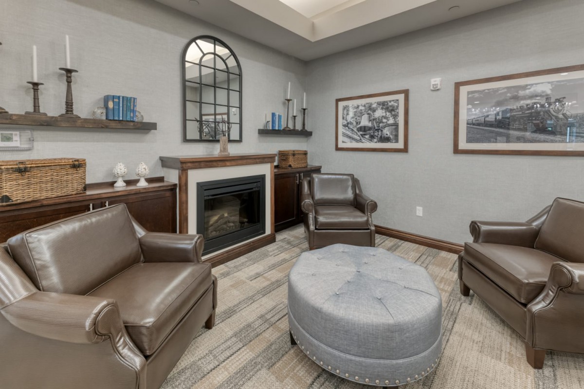 A cozy living room with a fireplace, comfortable seating, and elegant decor.