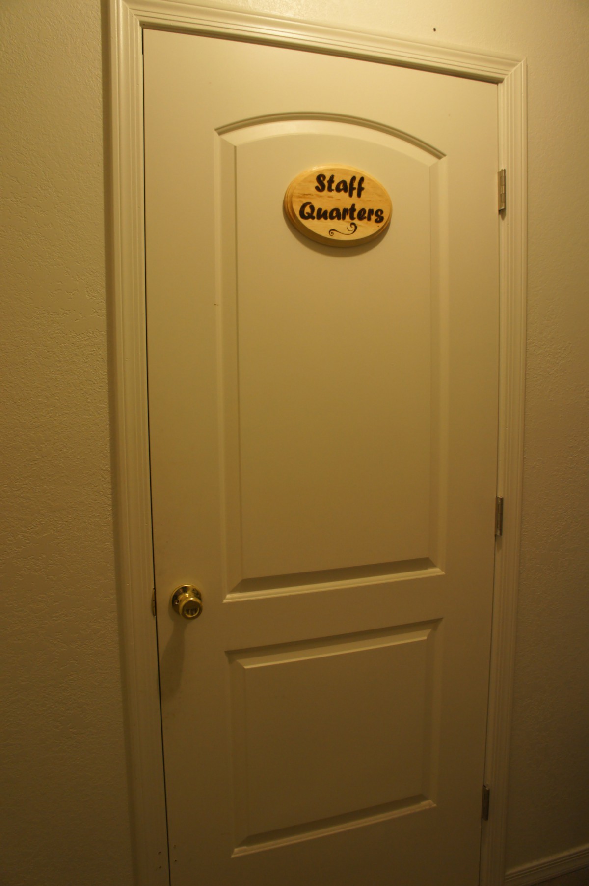 A door labeled 'Staff Quarters' with a small sign.