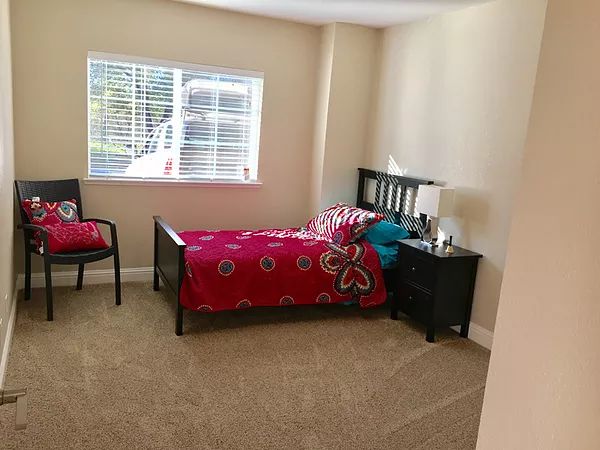 A cozy bedroom with a single bed and bright decor.