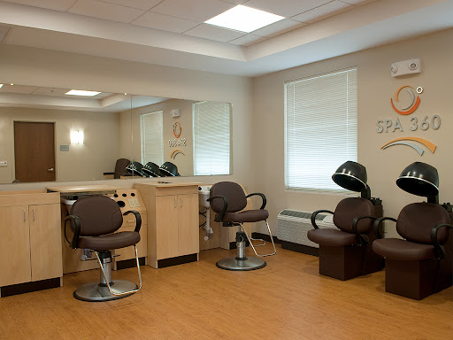 A modern hair salon interior with styling chairs and mirrors.