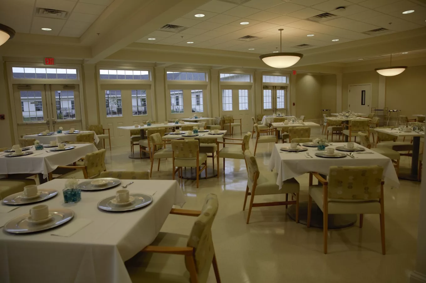 An elegant dining room with neatly arranged tables and chairs, ready for guests.