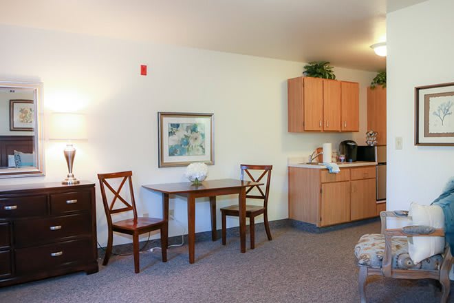 Cozy dining area with a small table and kitchenette.
