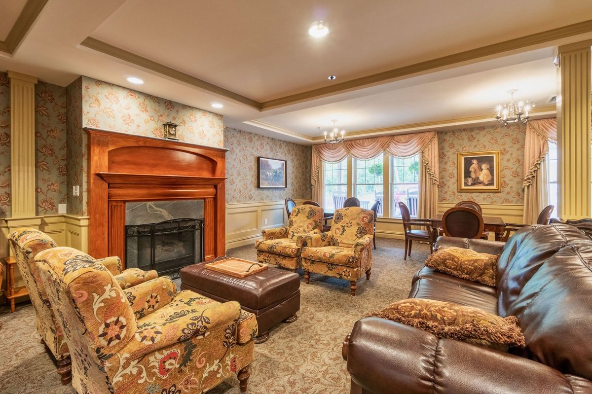 A cozy living room with elegant furniture and a warm fireplace.