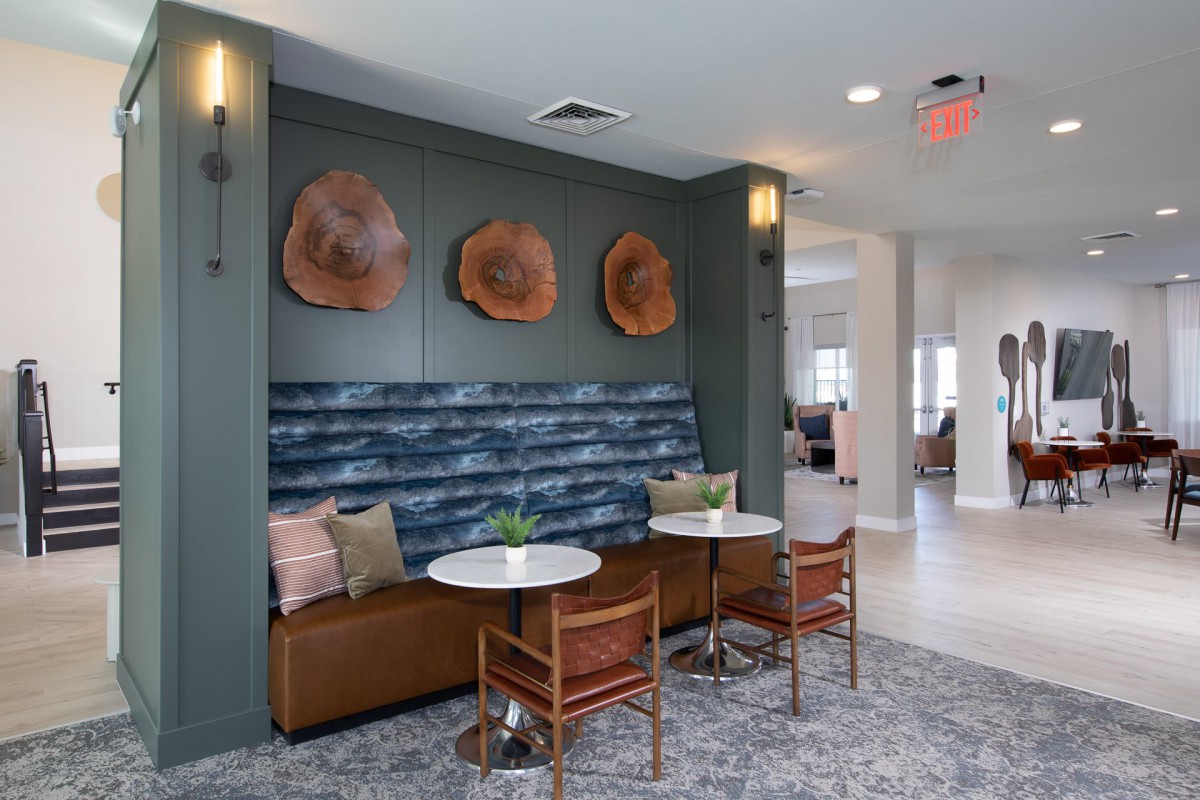 A modern cafe seating area with stylish furniture and unique wall art.