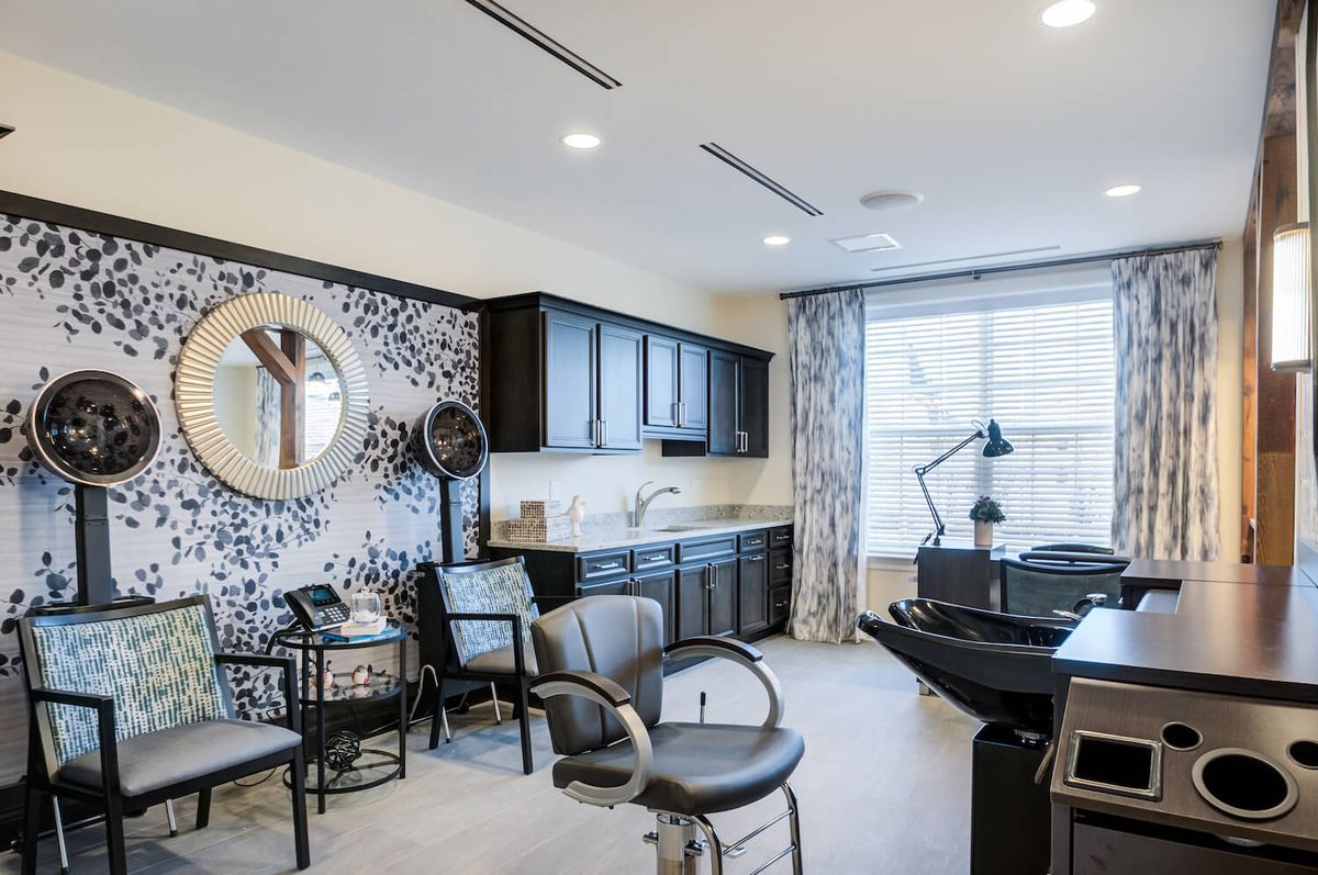 A modern hair salon with stylish decor and comfortable seating.