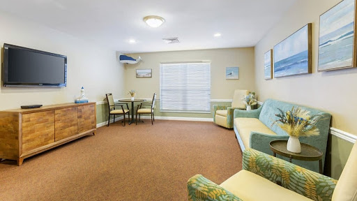 A cozy living room featuring comfortable seating and a dining area.