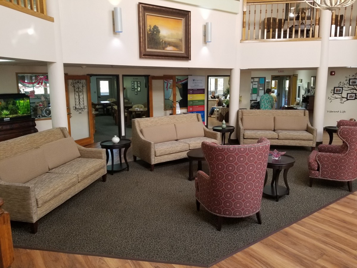 A cozy lobby with comfortable seating and artwork on the wall.