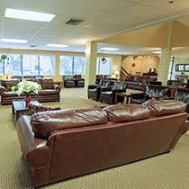 A spacious lounge area with leather sofas and ample natural light.
