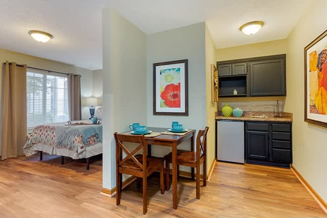 Cozy dining area with a small table and chairs adjacent to a compact kitchen.