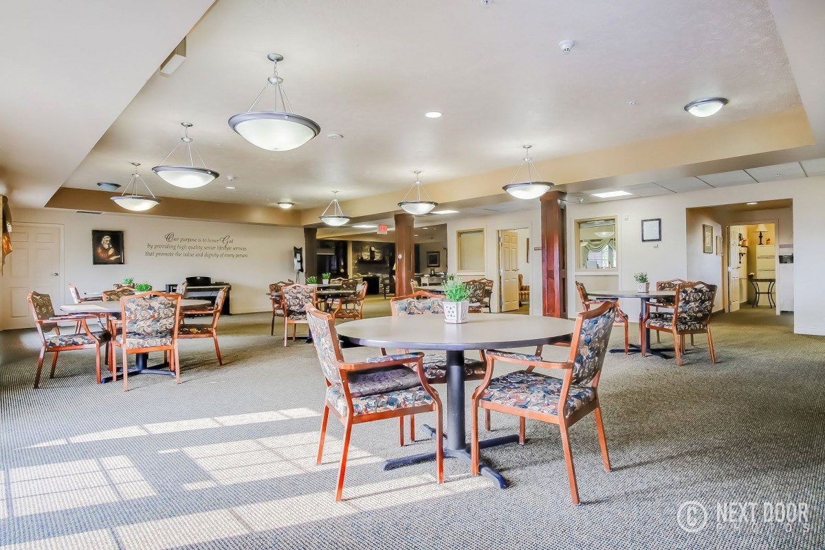 A spacious and well-lit dining area with tables and chairs arranged neatly.