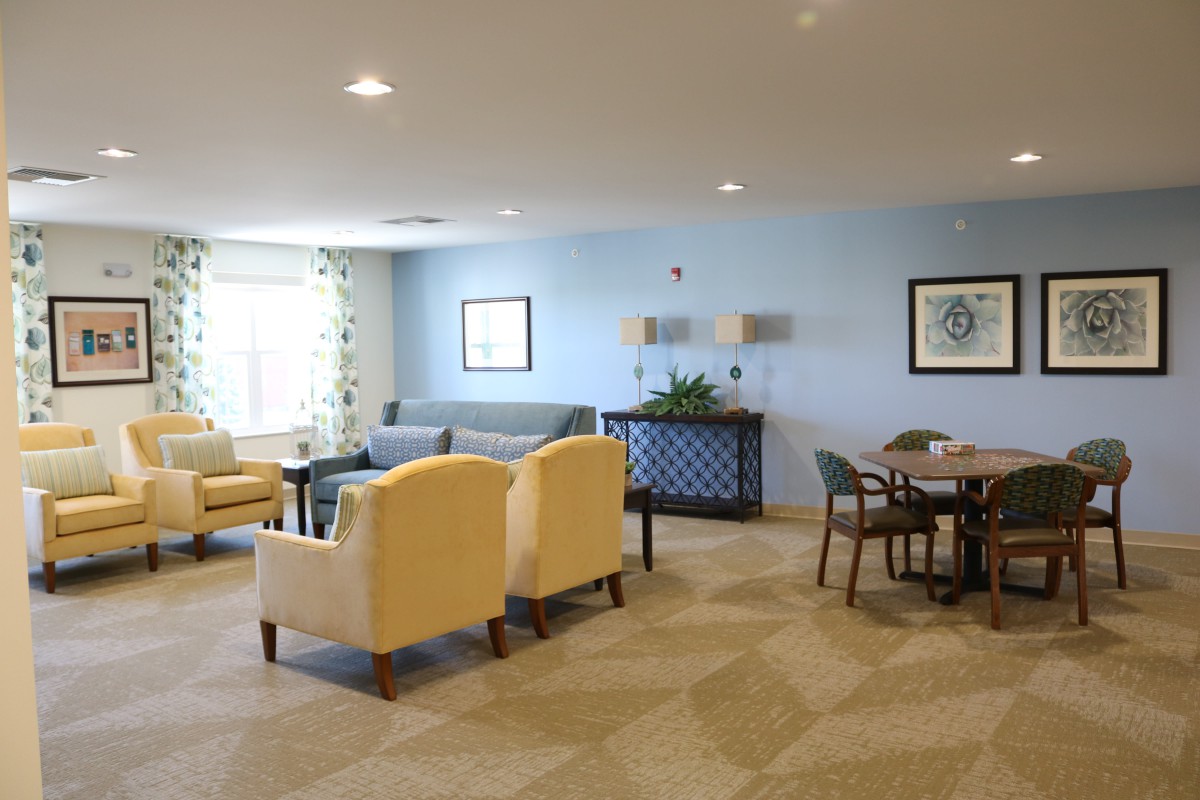 A spacious and well-lit living room with comfortable seating and modern decor.
