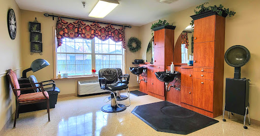 A well-lit barbershop featuring styling stations and a comfortable barber chair, creating an inviting atmosphere for clients.