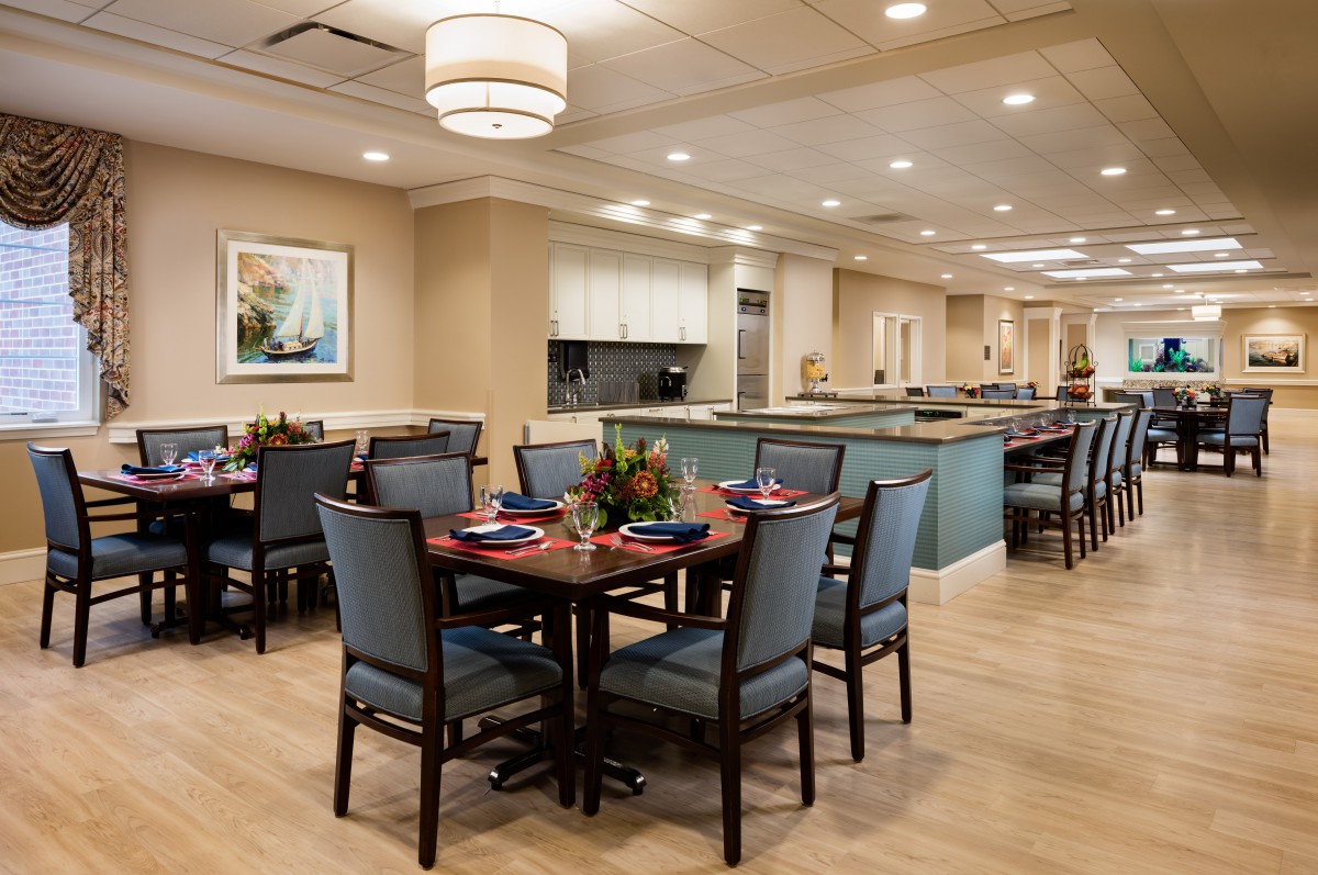 A modern dining room with neatly arranged tables and chairs.