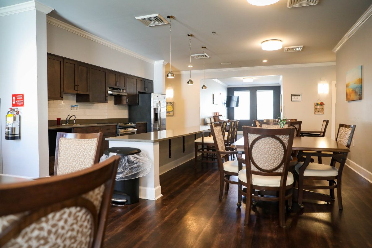 A modern kitchen and dining area with wooden flooring and stylish furniture.