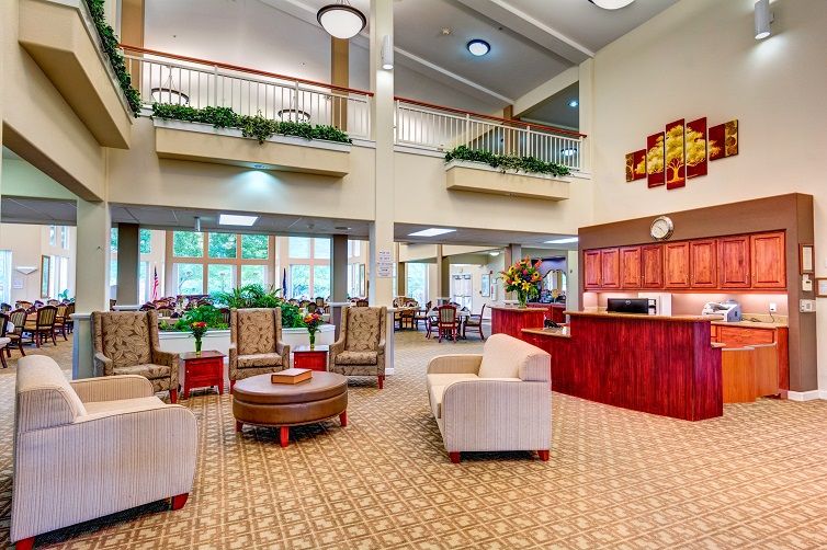 A spacious and modern hotel lobby with comfortable seating and a reception desk.