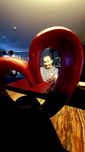 A playful portrait framed by a heart-shaped art installation.