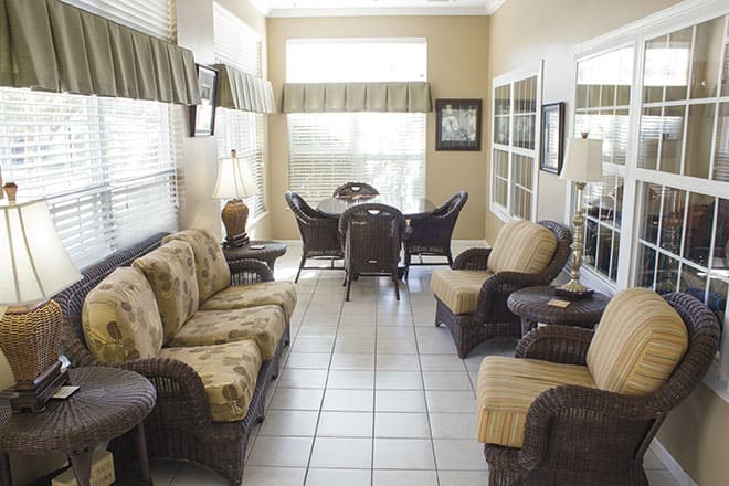 A cozy living room with rattan furniture and soft lighting.