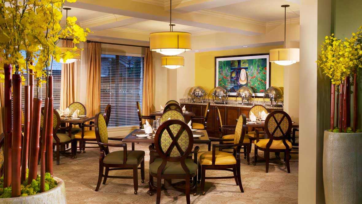 A cozy dining room with elegant furnishings and warm lighting.