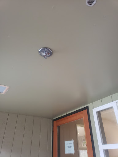 A close-up view of a ceiling featuring a modern light fixture.