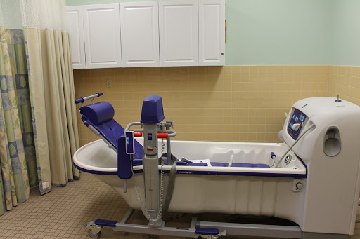 A hydrotherapy tub set up for rehabilitation purposes in a medical facility.