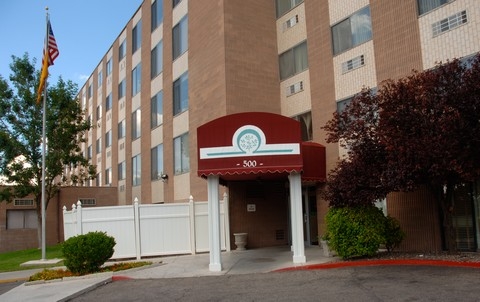 Hotel entrance showcasing modern architecture and a welcoming sign.