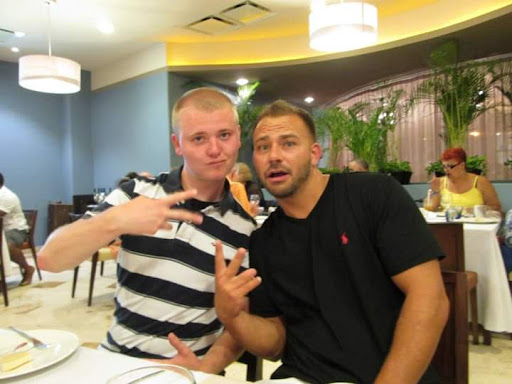 Two friends enjoying a lighthearted moment at a restaurant.