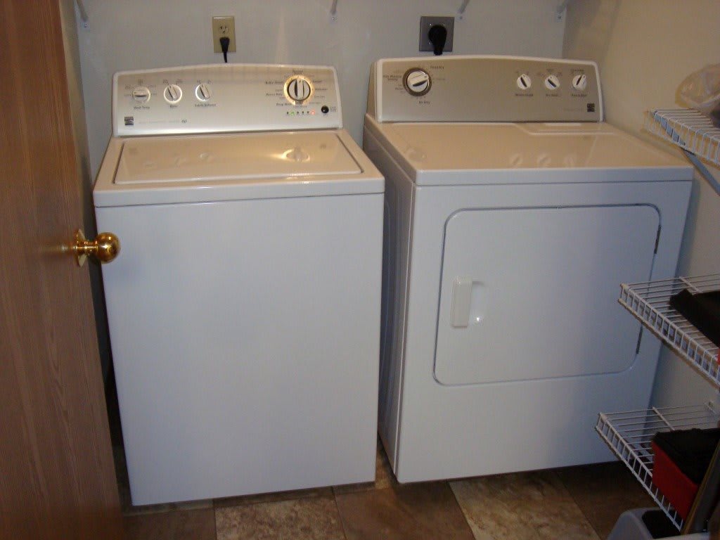 A pair of laundry appliances including a washing machine and a dryer in a laundry room.