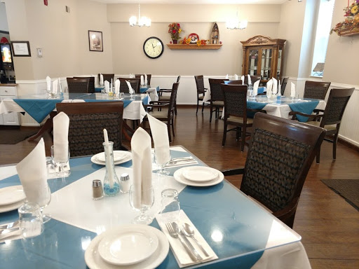 A beautifully arranged dining area with blue table settings and elegant decor.