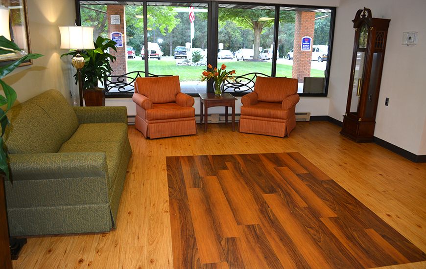 A cozy lobby area with comfortable seating and large windows letting in natural light.