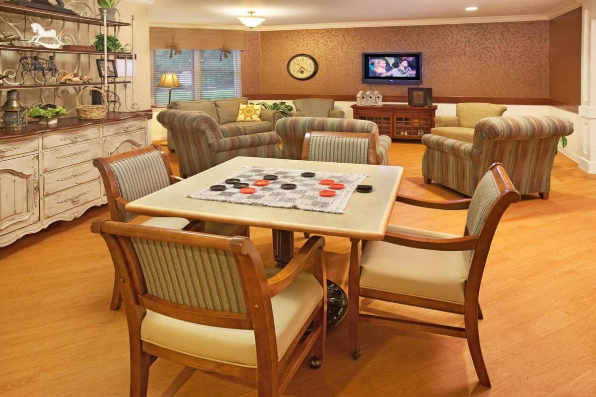 A cozy living room with a checkers board on the table and comfortable seating.