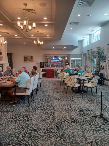 A lively dining area featuring groups of people enjoying a meal together.