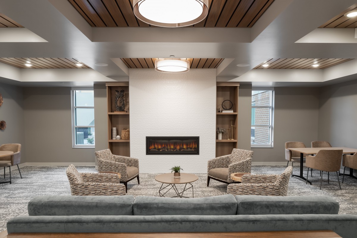 A modern living room with comfortable seating and a fireplace.