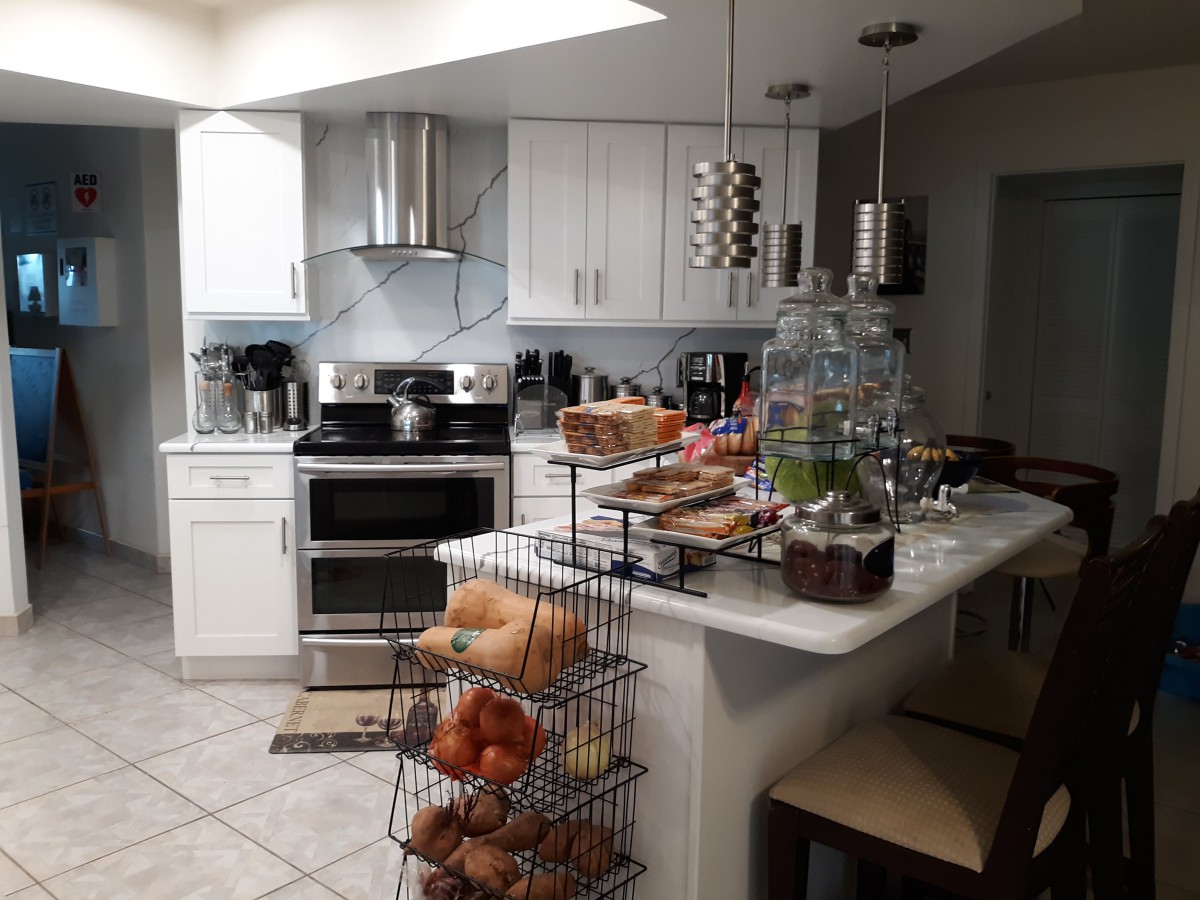 A modern kitchen with stainless steel appliances and a neatly organized countertop.