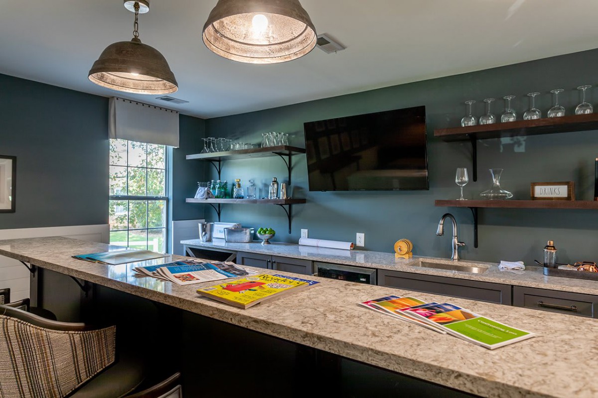 A modern kitchen with a spacious countertop, open shelves, and stylish lighting.