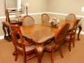 A cozy dining area featuring a wooden table and matching chairs.