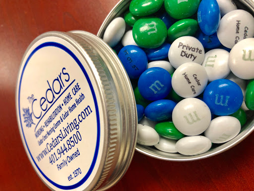 A tin filled with colorful M&Ms featuring a branding label for Cedars.