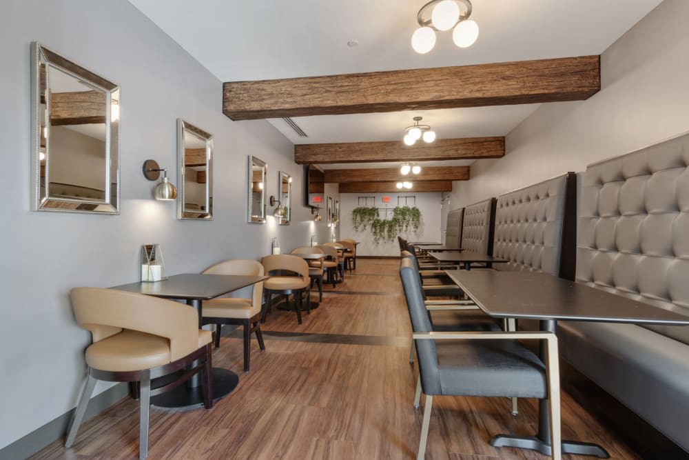A modern restaurant dining area featuring wooden beams and elegant seating arrangements.