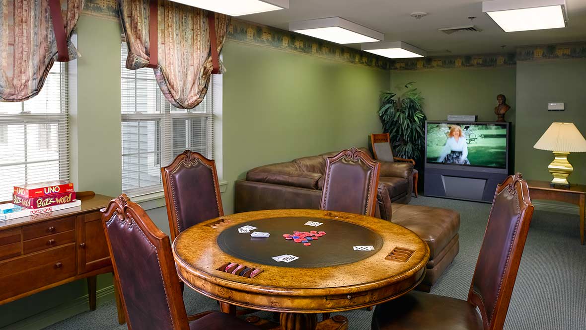 A cozy living room with a poker table and comfortable seating.