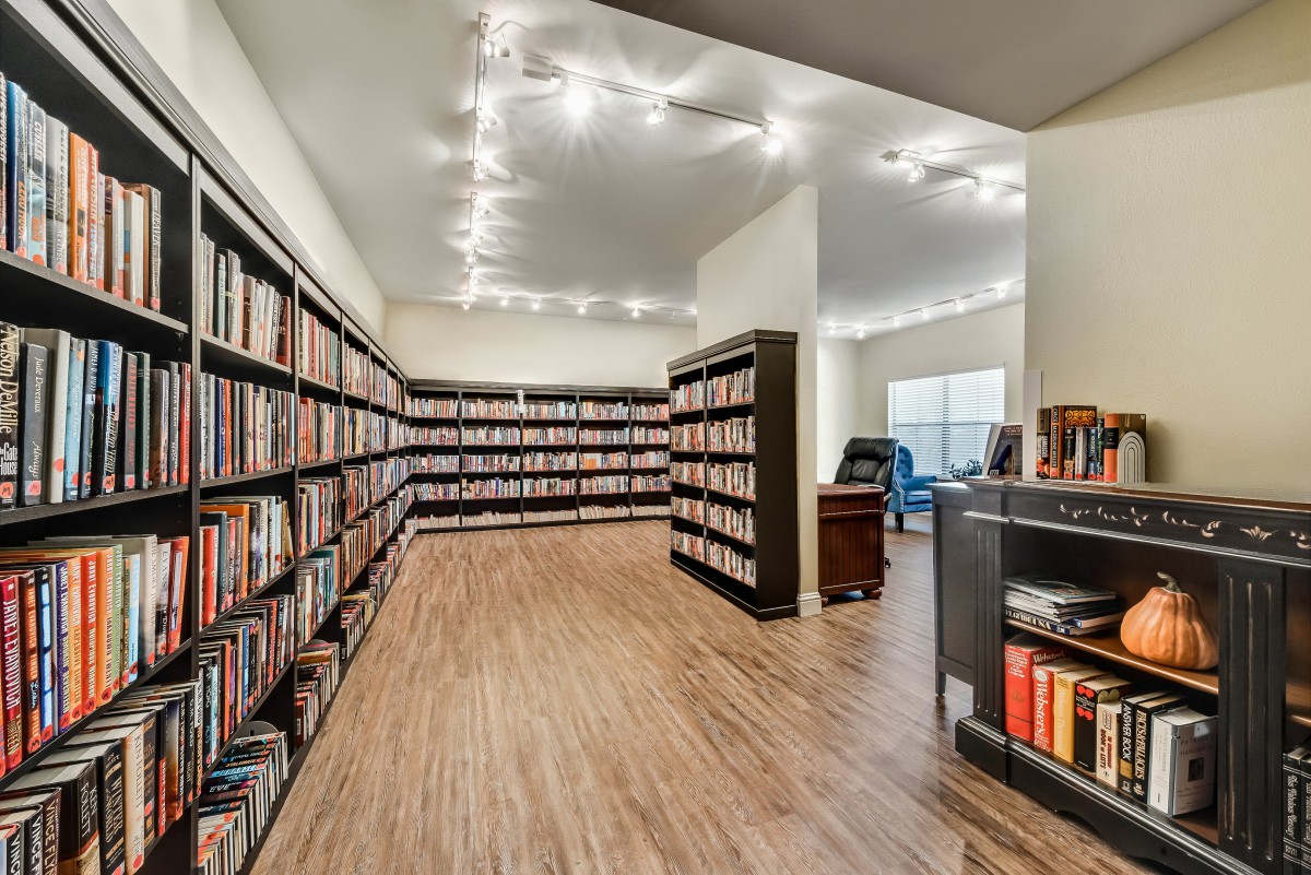 A modern library interior with bookshelves and a reading area.