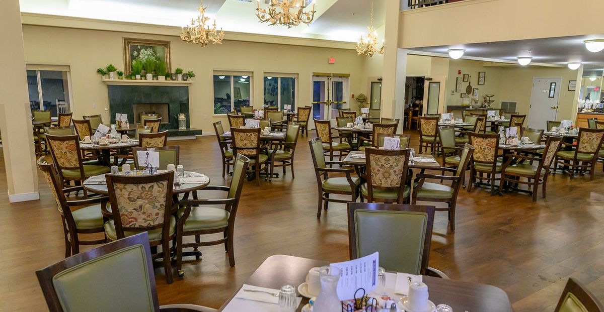 An elegant and empty dining area with neatly arranged tables and chairs.
