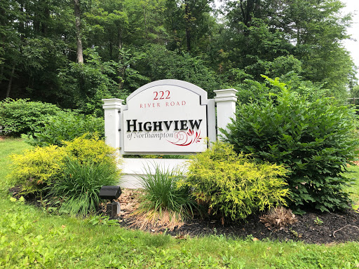 A welcoming sign for Highview surrounded by lush greenery.