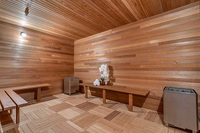 A serene wooden sauna room with benches and a relaxing atmosphere.