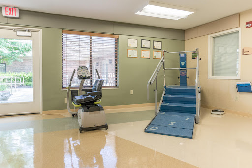 A well-equipped rehabilitation therapy room featuring exercise equipment and a ramp for accessibility.