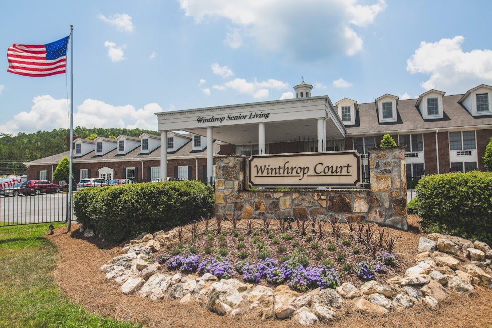 The entrance of Winthrop Court with a landscaped garden and visible signage.