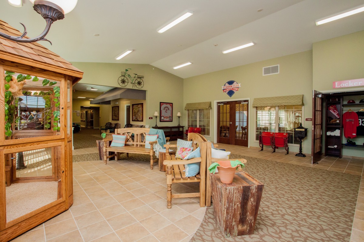A spacious lobby area with wooden furniture and decorative items.