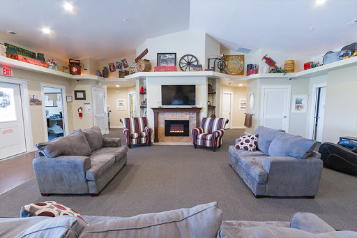 A cozy living room with comfortable seating and a welcoming fireplace, perfect for relaxation.
