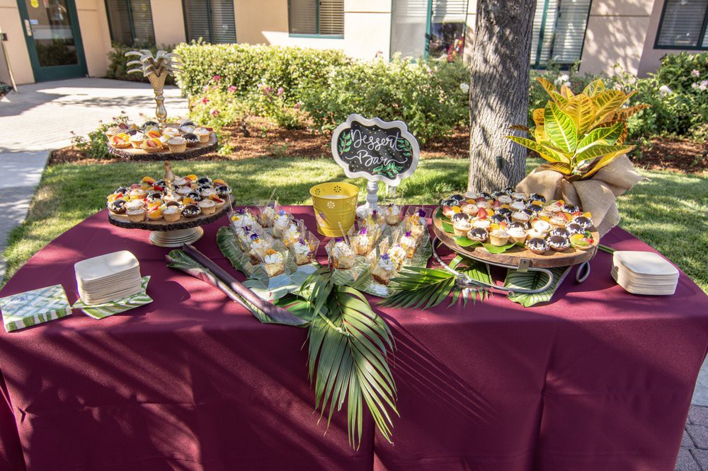 Outdoor buffet table with a variety of desserts beautifully presented for a party.