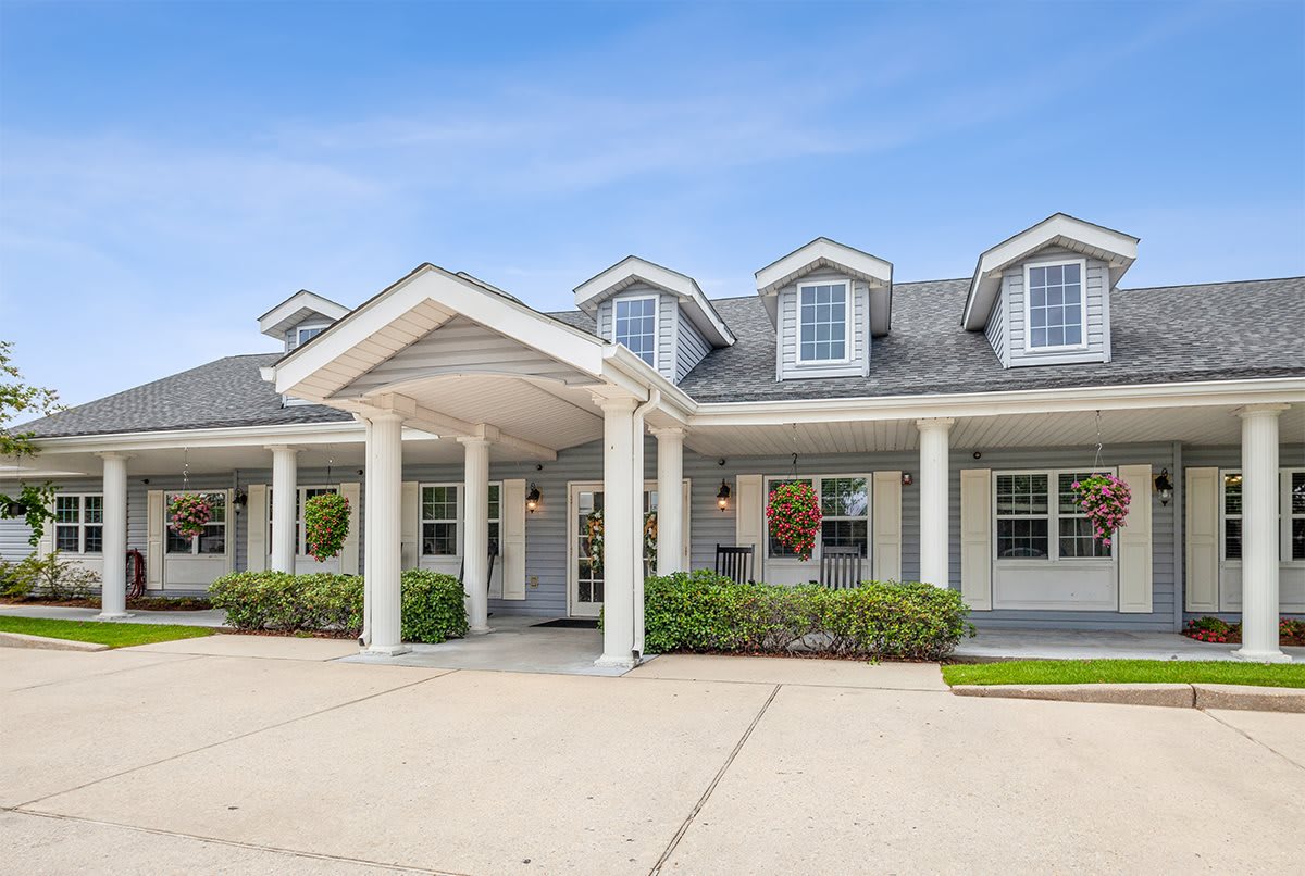 A picturesque, single-story house with a charming front porch and manicured shrubs.