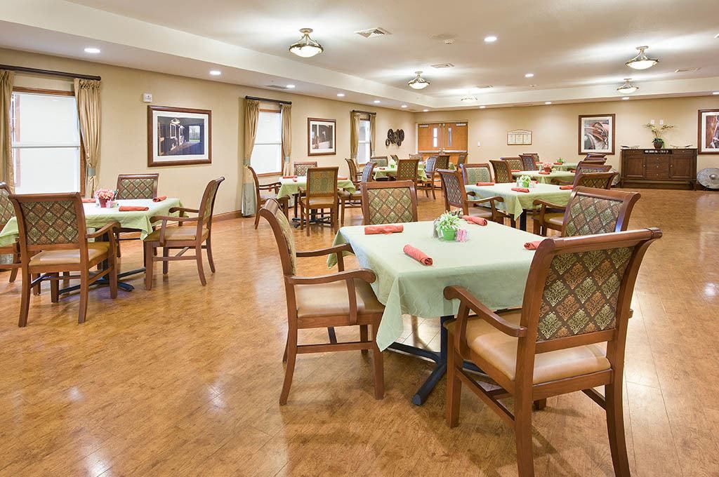 An elegantly arranged dining room with neatly set tables and comfortable chairs.